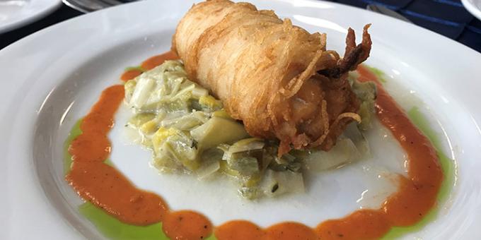 Plate of potato-crusted silverfin surrounded by sauces.