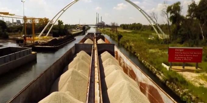 A loaded barge moving through a lock.
