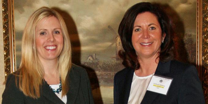 Two women pose for a photo.