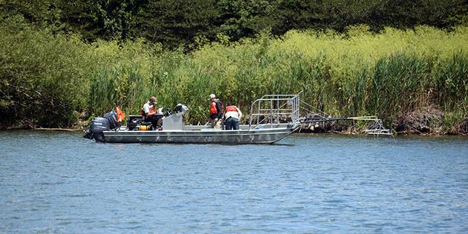 A field team at work on a boat.