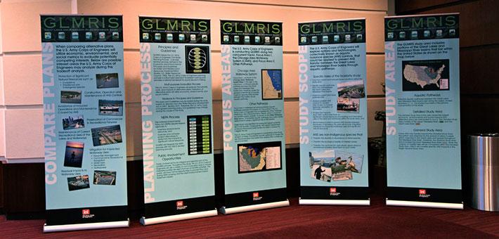 Exhibit panels on display showing images and text about the Great Lakes and Mississippi River Interbasin Study.