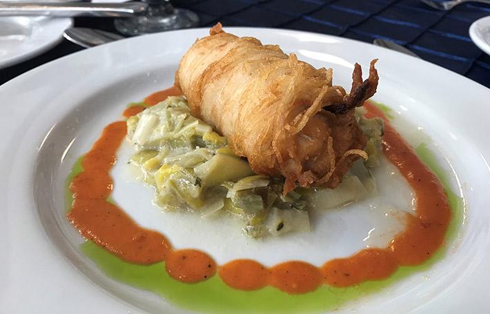 Plate of potato-crusted silverfin surrounded by sauces.